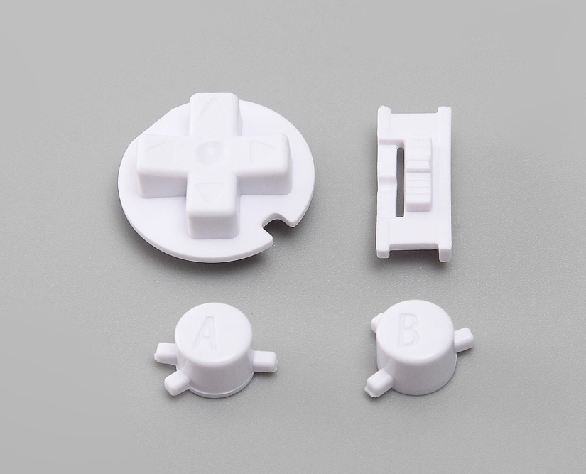 Set of white plastic components on a gray background
